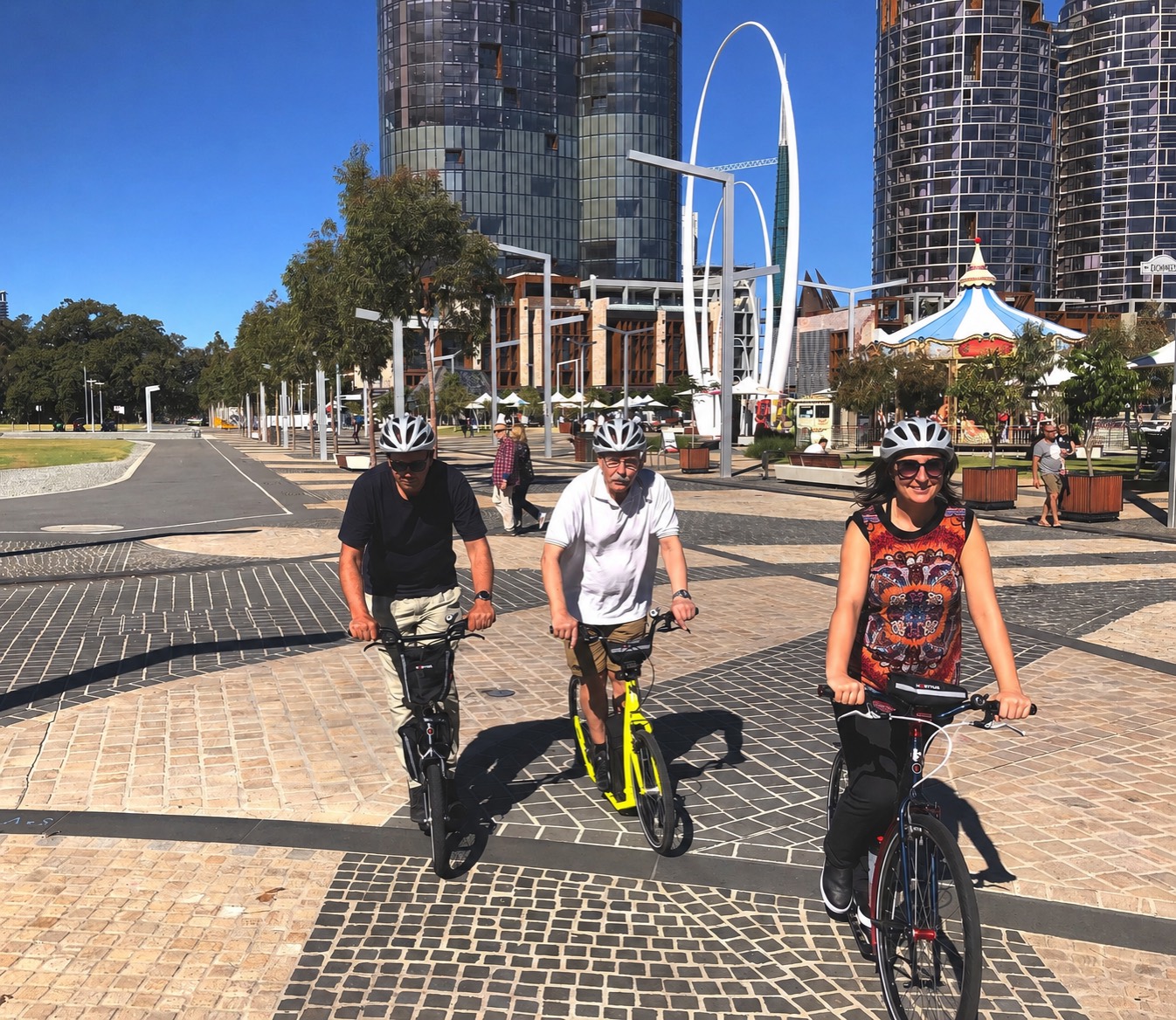 Three riders on footbikes at Elizabeth Quay in Perth